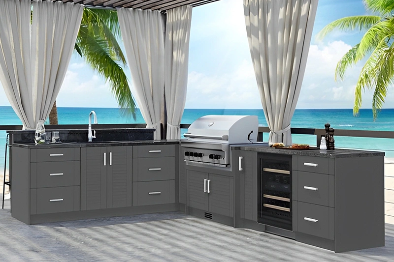 Outdoor kitchen setup with grill and ocean view.