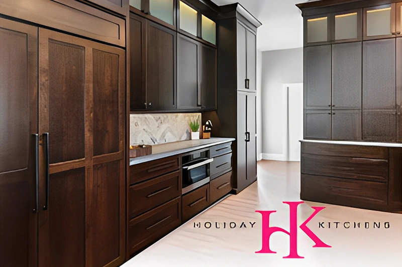 Modern kitchen with dark wood cabinets and white countertops.