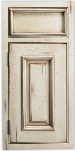A close-up of a beige wooden door with panel detailing and signs of wear.