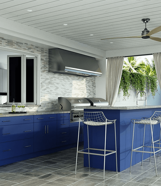 Modern kitchen with blue cabinets and a breakfast bar.