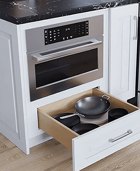 A kitchen drawer with pots and pans.