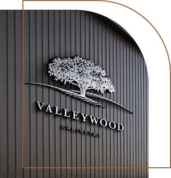 A close-up of Valleywood Cabinetry Warehouse signage.