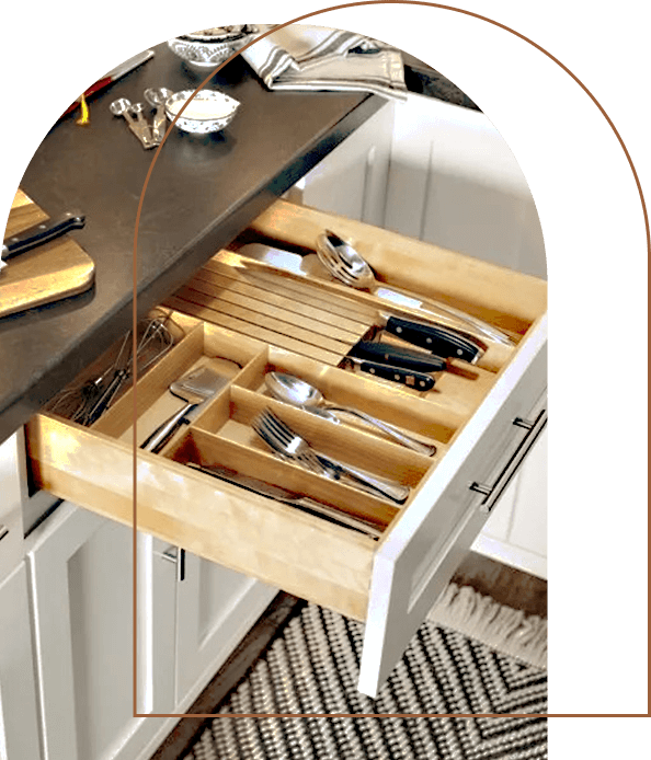 A close-up of a Valleywood cabinet drawer containing kitchen utensils and kitchen knives